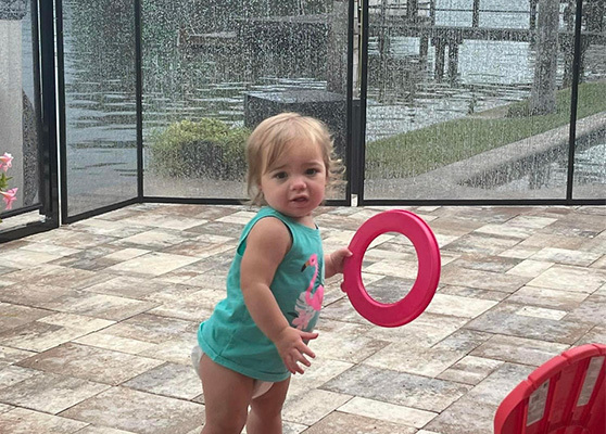 Little child playing by the poolside